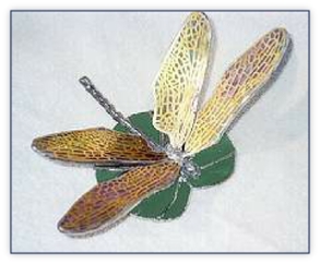 dragonfly with brass wings on lily pad