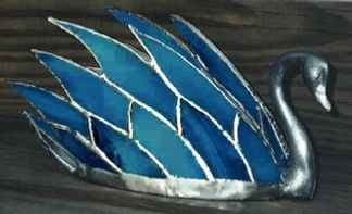 swan figure with glass feathers
